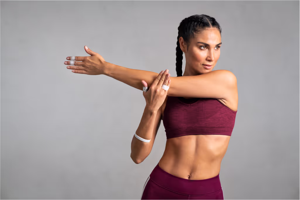 A woman stretching her arm muscles.
